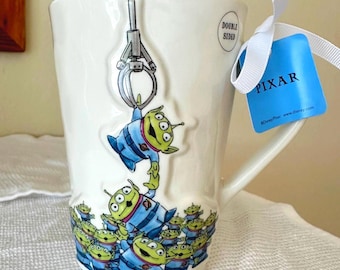 Rae Dunn Double Sided Coffee Mug -  ‘The Claw is Our Master” Disney Toy Story Characters Little Green Alien Men