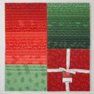 May include: A collection of Christmas-themed fabric squares in shades of red and green. The fabrics are arranged in a grid pattern, with some folded and stacked. One section is wrapped with a white ribbon and a tag.