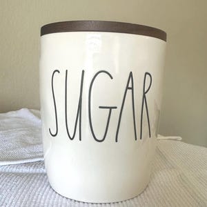 May include: A rustic wooden sign with the text "Welcome to our porch" in white lettering. The sign features a distressed finish and a simple, inviting design, perfect for outdoor decor.