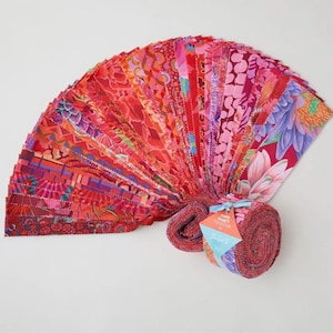 May include: A collection of fabric strips in shades of red, pink, and purple, fanned out to display various floral and abstract patterns. The fabric is rolled up at the base and tied with a blue ribbon.