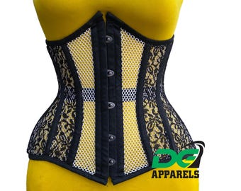May include: Black and white corset with a mesh panel and floral lace trim. The corset has a busk closure in the front and is made of a stretchy fabric. The corset is on a yellow mannequin.