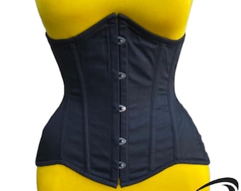May include: A black cotton corset with a busk closure and steel boning. The corset has a smooth, matte finish and is shown on a mannequin wearing a yellow top.