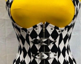 May include: A black and white diamond-patterned corset featuring a halter neck strap, a front zipper closure, and four horizontal buckle straps with metal hardware. The garment displays a repeating harlequin print and includes the text DG APPARELS.