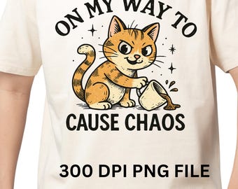 May include: Cream-colored t-shirt featuring a cartoon cat with orange and brown fur, spilling coffee from a mug. The text reads "ON MY WAY TO CAUSE CHAOS" in black, with "300 DPI PNG FILE" below.