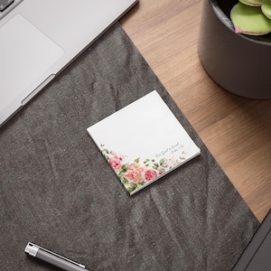 May include: A small white notepad with a floral design and the text "For God is love, John 4:8" printed on it.