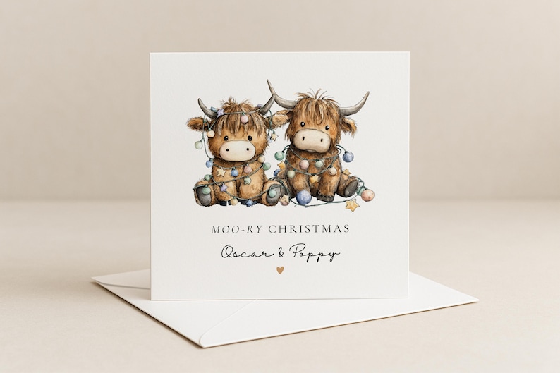 May include: A square greeting card featuring a watercolor illustration of two brown Highland cows tangled in colorful Christmas lights. The text reads MOO-RY CHRISTMAS and Oscar & Poppy with a small heart symbol below the names on a white background.