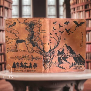 May include: A brown leather book cover featuring a map, a stag illustration, and the phrases "To Whatever End" and "You Do Not Yield." The cover also includes the text "Property of Heather" and "Fireheart."