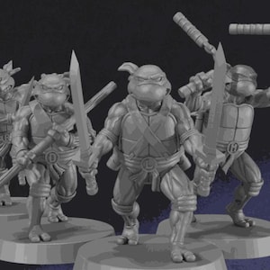 May include: A group of four gray Teenage Mutant Ninja Turtle figurines. Each figure is posed with a weapon, including swords and nunchucks. The figures are standing on round bases, with the letter of each turtle visible.