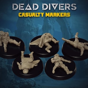 May include: Five unpainted tan miniature figures labeled DEAD DIVERS CASUALTY MARKERS. Each figure is in a different prone or fallen pose, wearing tactical gear and helmets, mounted on individual circular black bases against a blue background.