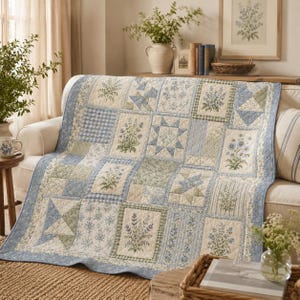 May include: A patchwork quilt featuring a variety of rectangular and square blocks with blue and green floral prints, gingham patterns, and geometric star designs. The quilt has a light blue border and visible stitching throughout the fabric.