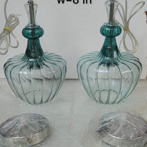 May include: Two clear glass pendant lights with teal accents and a ribbed design. Each light is approximately 8 inches (20 cm) wide. The text "custom order w=8 in" is visible in the image.