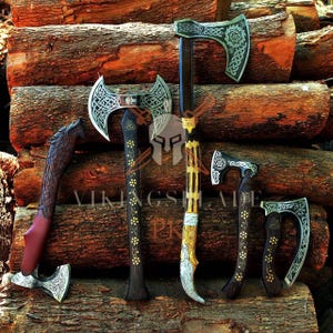 May include: A collection of six axes with wooden handles and silver-colored blades. The axes feature intricate designs and patterns, with some having decorative elements. The axes are displayed on a background of stacked logs.