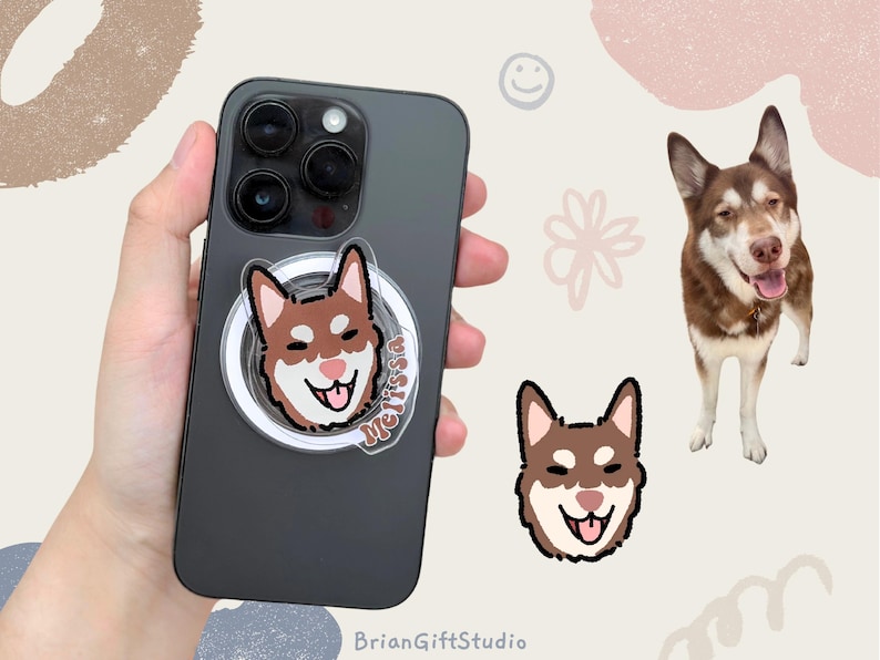 May include: A black phone case with a clear phone grip featuring a cartoon illustration of a brown and white dog with the name "Melissa" written on the grip.