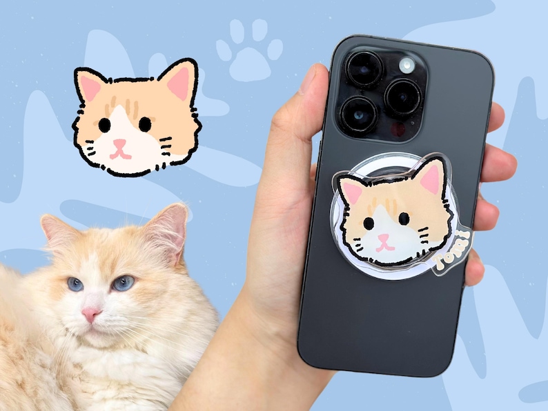 May include: A black iPhone case with a clear phone ring holder featuring a cartoon orange and white cat face. The phone ring holder has the word "Meow" printed on it.