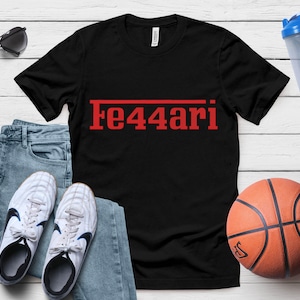 May include: Black t-shirt with the red text "Fe44ari" printed across the front. The shirt is paired with blue jeans, white sneakers, and a basketball. Sunglasses and a water bottle are also visible.