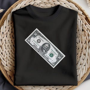 May include: Black t-shirt with a fifty dollar bill printed on the front. The bill features a portrait of Ulysses S. Grant.
