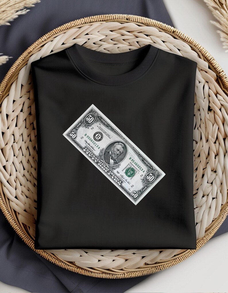 May include: Black t-shirt with a fifty dollar bill printed on the front. The bill features a portrait of Ulysses S. Grant.