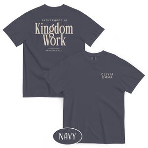 May include: Navy blue t-shirts with the text "FATHERHOOD IS Kingdom Work" and "PROVERBS 22:6" printed on the back. The front of the shirt has the text "OLIVIA EMMA". The word "NAVY" is in a navy oval.