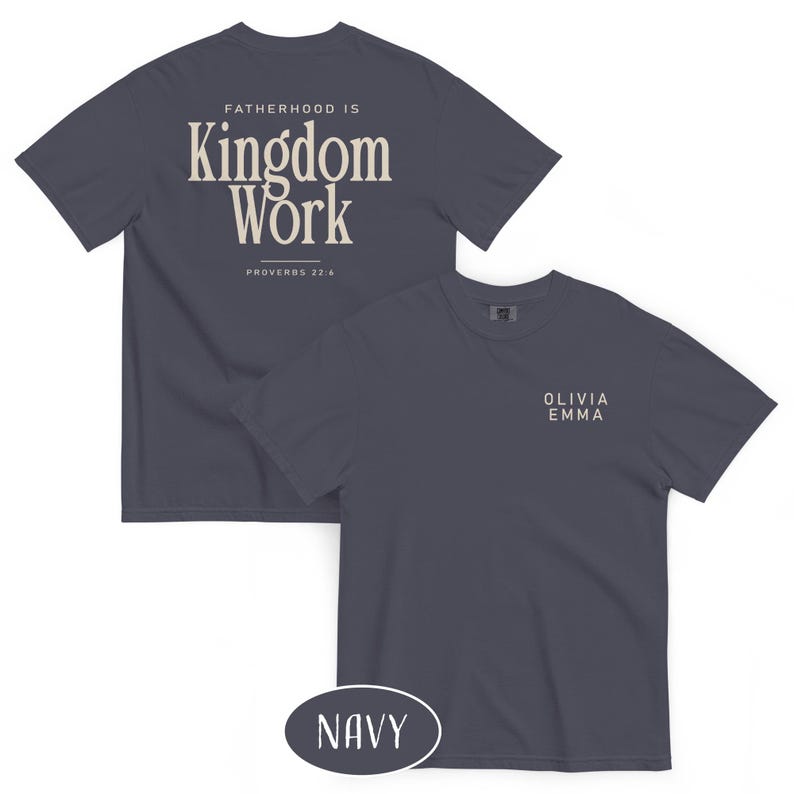 May include: Navy blue t-shirts with the text "FATHERHOOD IS Kingdom Work" and "PROVERBS 22:6" printed on the back. The front of the shirt has the text "OLIVIA EMMA". The word "NAVY" is in a navy oval.