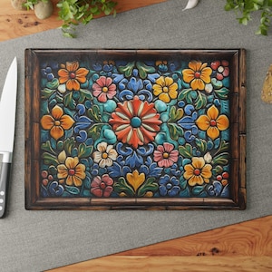 May include: A colorful floral design on a wooden cutting board. The design features a variety of flowers in shades of red, orange, yellow, blue, and green. The flowers are arranged in a symmetrical pattern and are surrounded by a dark brown frame.