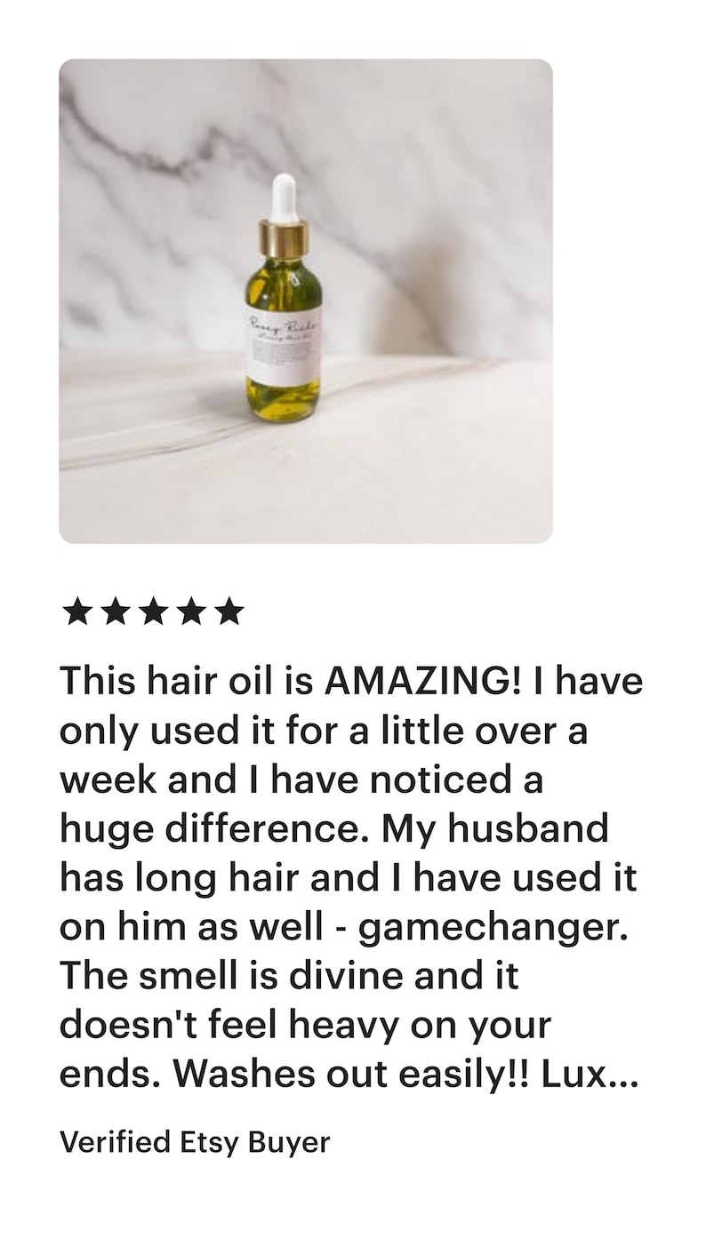May include: A glass bottle of hair oil with a gold dropper and a white label that reads "Every Body Hair Oil". The bottle is sitting on a white marble surface.