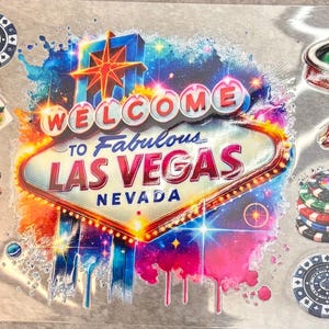 May include: A decorative sheet featuring the Welcome to Fabulous Las Vegas Nevada sign in the center, surrounded by illustrations of green poker tables, stacks of colorful casino chips, and playing cards with vibrant, multi-colored suit designs.