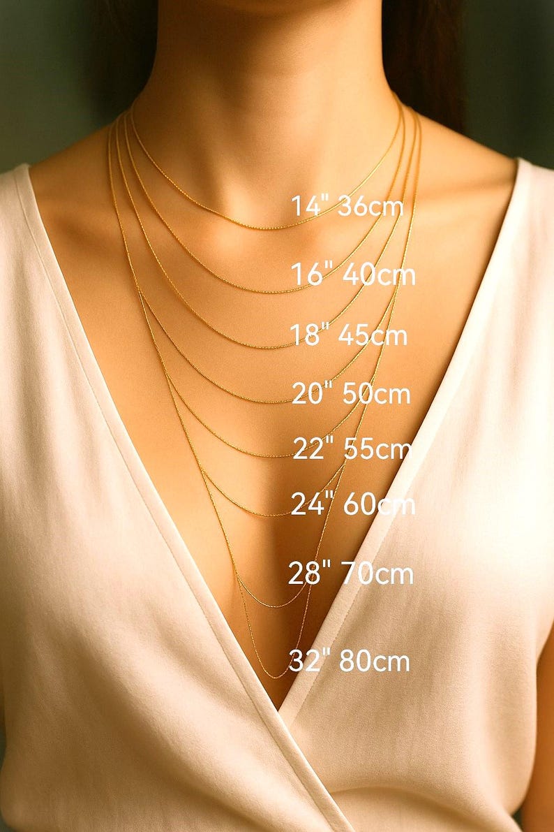 a close-up of a person's neck with multiple gold necklaces of varying lengths, each labeled with its corresponding size in centimeters.