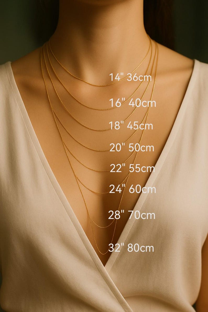 a close-up of a person's neck with multiple gold necklaces of varying lengths, each labeled with its corresponding size in centimeters.