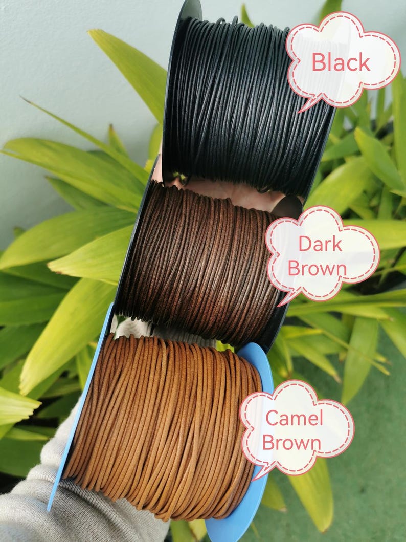 A hand holding a spool of leather cord in three different colors: black, brown, and camel brown. The cord is arranged in a row, with each color represented by a speech bubble above it.