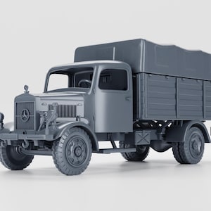 May include: A gray model of a vintage truck with a covered cargo bed. The truck features a detailed front grille, headlights, and large tires. The cab has a windshield and doors. The overall design is a classic representation of a mid-century truck.