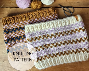 May include: Two knitted neck warmers with a chevron pattern in brown, white, and purple yarn. The warmers are laid out on a wooden surface with balls of yarn in various colors.