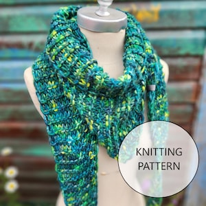 May include: A green, blue, and yellow knitted scarf with a textured pattern. The scarf is draped over a white mannequin. The text "Knitting Pattern" is visible in the image.