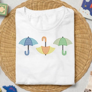 傘のスケッチ模様を春らしい刺繍デザインに取り入れた、子供服やトートバッグのアクセント（即時ダウンロード）