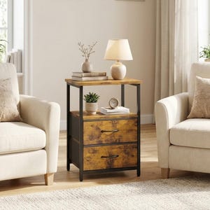 May include: A rectangular side table with a black metal frame and two drawers featuring a rustic brown wood grain finish. The top surface holds a beige table lamp, a small vase with dried stems, and books. A small potted plant and clock sit on the shelf.