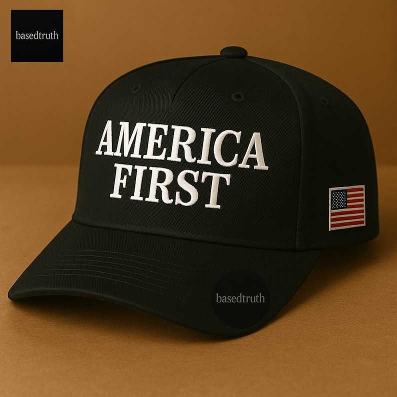 May include: Black baseball cap with the words "AMERICA FIRST" embroidered in white. A small American flag patch is on the side. The cap has a curved brim and a button on top.