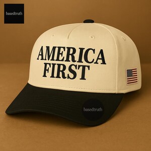 May include: A baseball cap with a cream-colored crown and a black brim. The words "AMERICA FIRST" are printed in bold black letters on the front. A small American flag patch is on the side. The brand name "basedtruth" is printed on the side and top.
