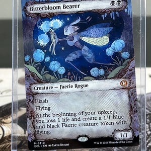 May include: A Magic: The Gathering card titled "Bitterbloom Bearer." The card features a blue and gray faerie-like creature with blue wings and holding blue glowing orbs. The card has text describing its abilities and is in a protective sleeve.