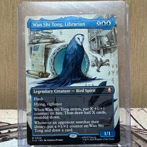 May include: A Magic: The Gathering card featuring "Wan Shi Tong, Librarian," a Legendary Creature Bird Spirit. The card has a blue and white color scheme with detailed artwork of an owl. The card is in a protective sleeve.
