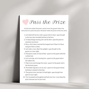 May include: A pink heart graphic with the text "Pass the Prize" in black text. The text below the graphic explains how to play a game where guests pass a prize around following instructions.