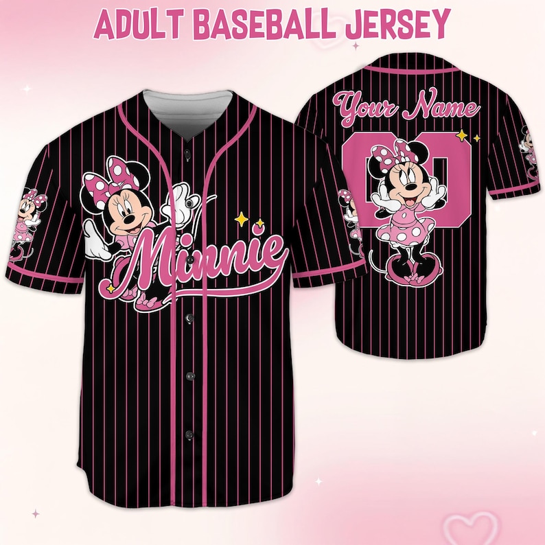 May include: Black baseball jersey with pink pinstripes, featuring Minnie Mouse graphics. The front displays "Minnie" in pink script, while the back has a pink number and space for a name. The jersey has a button-up front and short sleeves.