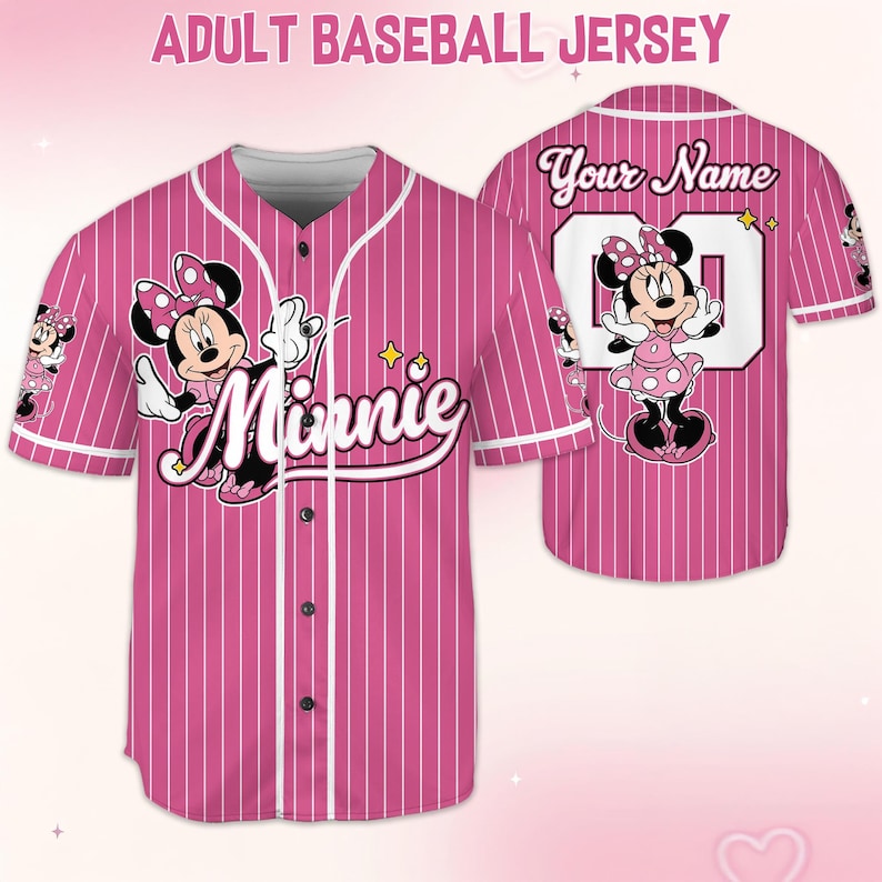May include: Pink and white striped adult baseball jersey featuring Minnie Mouse. The front displays Minnie with the word "Minnie" in cursive. The back has the text "Your Name" above a number. The sleeves have Minnie Mouse graphics.