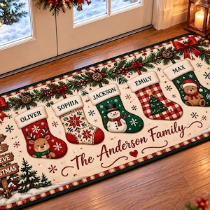 May include: A rectangular Christmas-themed floor mat featuring five hanging stockings labeled Oliver, Sophia, Jackson, Emily, and Max. The mat displays the text The Anderson Family, Joy, Love, Believe, and Christmas, with festive illustrations of reindeer, a snowman, a teddy bear, pine branches, and red bows.