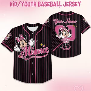 May include: Black and pink pinstripe baseball jersey with a Minnie Mouse graphic. The front features the word "Minnie" in pink script, and the back has a pink number 00 and the words "Your Name". The jersey is labeled "Kid/Youth Baseball Jersey".