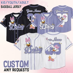 May include: Baseball jerseys with Daisy Duck graphics. The jerseys are available in black, white, and lavender with pinstripes. The text "Daisy" is featured on the front, and "Your Name" can be added to the back. The image also includes the text "CUSTOM ANY REQUESTS".