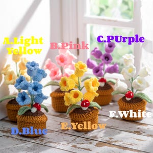 May include: A collection of handmade crochet flower arrangements in small brown pots. The flowers are in various colors, including light yellow, pink, purple, blue, and white. Each pot has a small mushroom decoration. The text on the image reads: A. Light Yellow, B. Pink, C. Purple, D. Blue, E. Yellow, F. White.