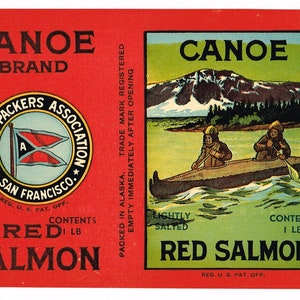 May include: A red and white label for a can of Canoe Brand lightly salted red salmon. The label features a logo for the Alaska Packers Association, a scene of two people in a canoe, and a salmon leaping out of the water. The text on the label reads "Canoe Brand Lightly Salted Red Salmon, Contents 1 lb. Packed in Alaska. Trade Mark Registered. Empty Immediately After Opening. Net Contents - 1 lb. Fresh Salmon - 3 oz. Salt. Cooked in Can After Sealing."
