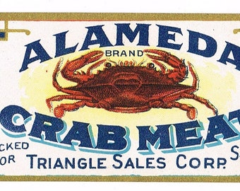 May include: A vintage label for Alameda Brand Crab Meat, packed for Triangle Sales Corp. in Salem, Mass. The label features a red crab on a yellow background with blue text. The label also states that the product is from Japan and contains 6 1/2 ounces.