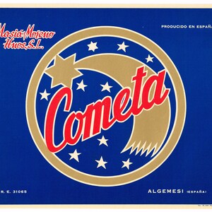 May include: A vintage label with a blue background features a gold and red comet design. The word "Cometa" is in red script, surrounded by a gold arc and white stars. Text includes "Masia Moreno Huos, S.L." and "Producido en España."