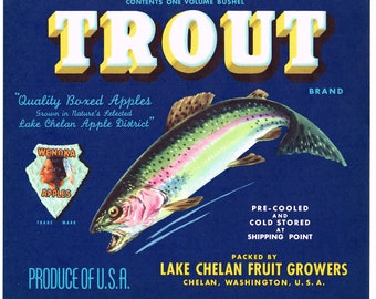 May include: A vintage label for Trout Brand apples, featuring a rainbow trout jumping out of the water. The label is blue with yellow and white text. The text reads "Trout Brand", "Quality Boxed Apples", "Grown in Nature's Selected Lake Chelan Apple District", "Wenoka Apples", "Produce of U.S.A.", "Pre-Cooled and Cold Stored at Shipping Point", "Packed by Lake Chelan Fruit Growers", "Chelan, Washington, U.S.A."