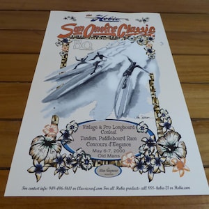 May include: Poster for the Hobie San Onofre Classic, a vintage and pro longboard contest. The poster features a watercolor illustration of surfers on longboards, with floral accents and event details. The event took place May 6-7, 2000.